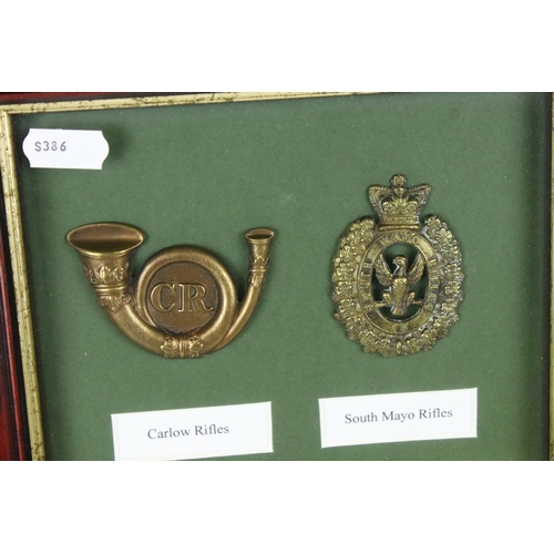 170 - A Framed And Glazed Collection Of Eight British Military Cap Badges To Include The Queens County Rif... 