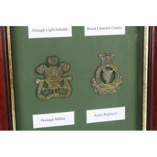 170 - A Framed And Glazed Collection Of Eight British Military Cap Badges To Include The Queens County Rif... 