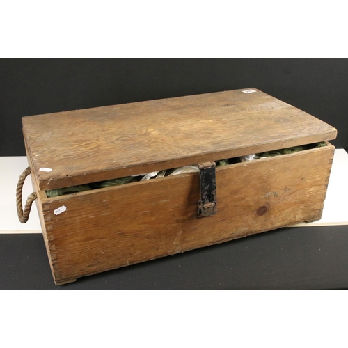 384 - A used parachute contained within a large wooden military box.