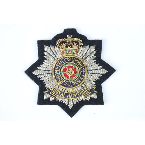 204 - A British Military The Royal Hampshire Queens Crown Cloth Badge.