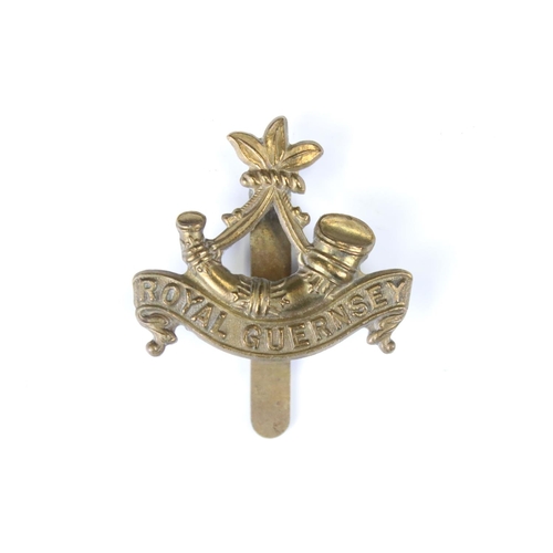 213 - A British Military The Royal Guernsey Regiment Brass Cap Badge, Complete With Slider Fixing To The V... 