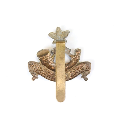 213 - A British Military The Royal Guernsey Regiment Brass Cap Badge, Complete With Slider Fixing To The V... 