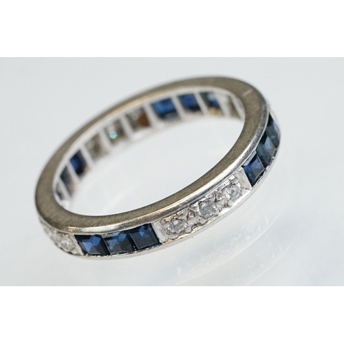 9 - Diamond and sapphire white metal eternity ring, a total of twelve round brilliant cut diamonds, pavé... 