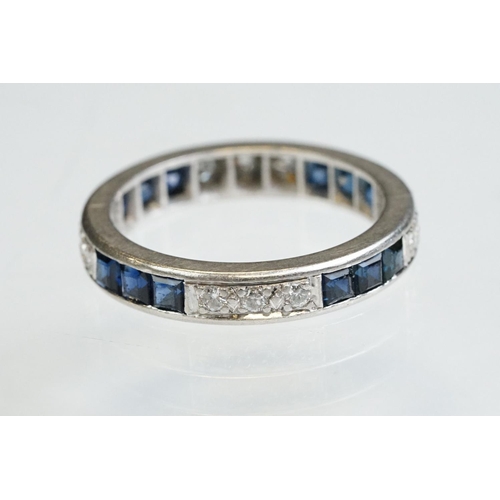 9 - Diamond and sapphire white metal eternity ring, a total of twelve round brilliant cut diamonds, pavé... 