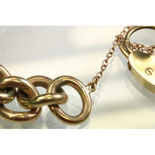 42 - 9ct yellow gold curb link bracelet, with padlock clasp and safety chain, each link stamped .375 and ... 