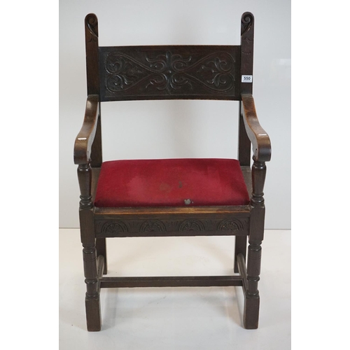 578 - In the manner of Liberty of London, Gothic Revival Oak Elbow Chair with carved back rail and upholst... 