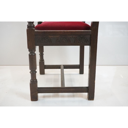 578 - In the manner of Liberty of London, Gothic Revival Oak Elbow Chair with carved back rail and upholst... 