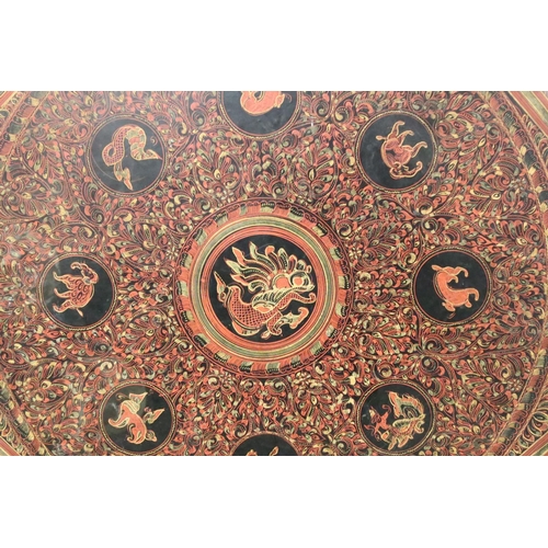 624 - Burmese Red and Black Lacquered Octagonal Folding Table decorated with images of figures, birds, ani... 