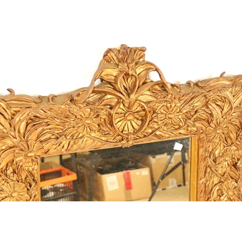 542 - Heavy ornate gilt framed wall mirror, 97cm x 68cm