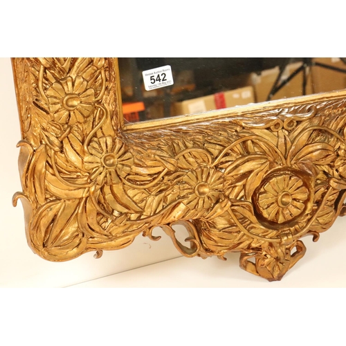 542 - Heavy ornate gilt framed wall mirror, 97cm x 68cm