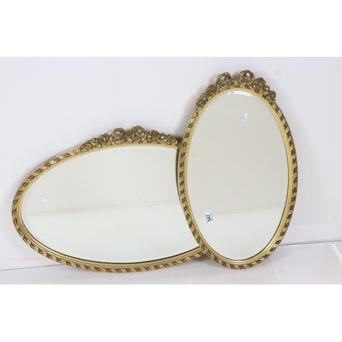 547 - Two Gilt Framed Oval Wall Mirrors, each with ribbon and garland cresting, largest 72cm x 45cm