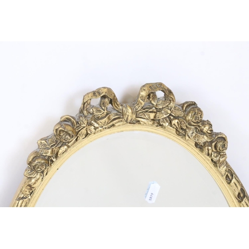 547 - Two Gilt Framed Oval Wall Mirrors, each with ribbon and garland cresting, largest 72cm x 45cm