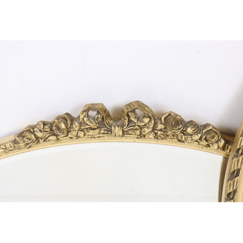 547 - Two Gilt Framed Oval Wall Mirrors, each with ribbon and garland cresting, largest 72cm x 45cm