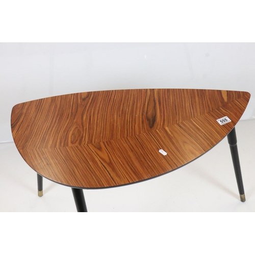 555 - Mid century Retro Coffee Table with wood effect shaped top, raised on three black tapering legs, 77c... 