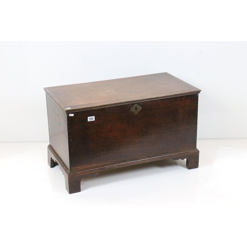 556 - 18th century Oak Coffer with hinged lid raised on bracket feet, 81cm wide x 44cm deep x 49cm high