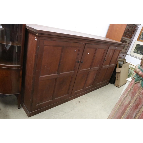 563 - Late 19th / Early 20th century Large Stained Pine Cupboard, the three panel doors opening to shelves... 