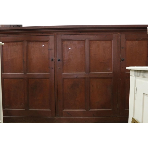 563 - Late 19th / Early 20th century Large Stained Pine Cupboard, the three panel doors opening to shelves... 