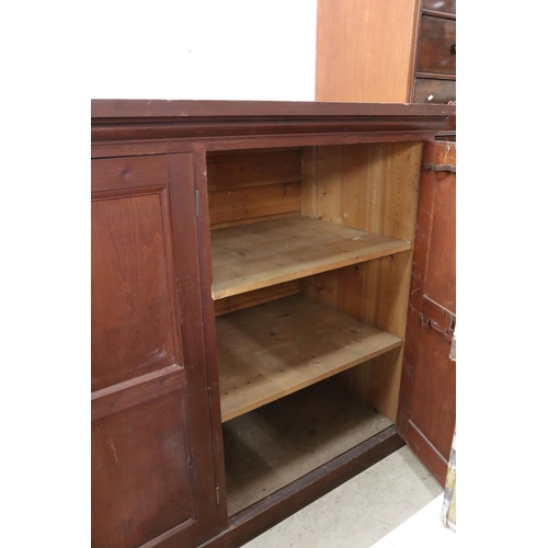 563 - Late 19th / Early 20th century Large Stained Pine Cupboard, the three panel doors opening to shelves... 