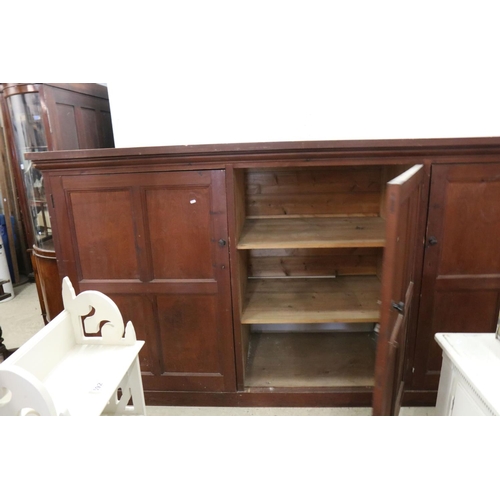 563 - Late 19th / Early 20th century Large Stained Pine Cupboard, the three panel doors opening to shelves... 