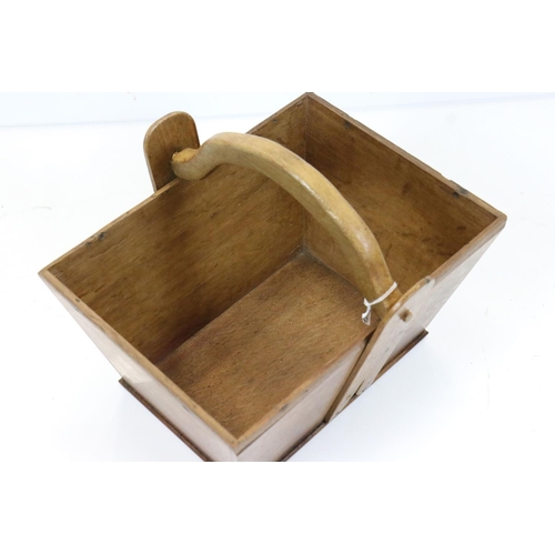 566 - Oak trug with swing handle and Army & Navy CSL label to base, 34cm long