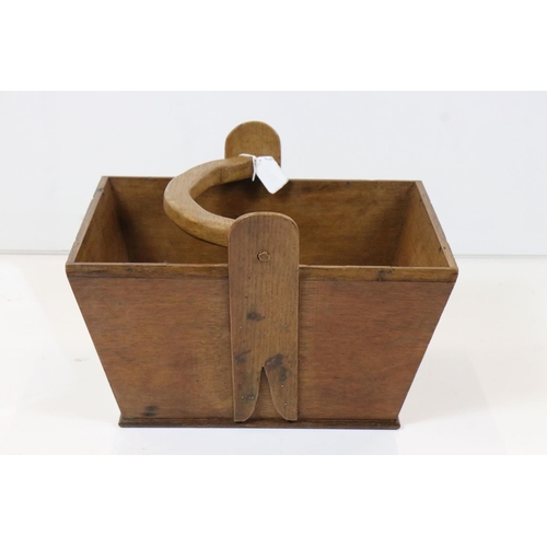 566 - Oak trug with swing handle and Army & Navy CSL label to base, 34cm long