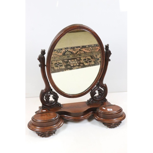 569 - Victorian Mahogany Oval Swing Mirror held on a shaped base with two hinged lid compartments, 80cm wi... 