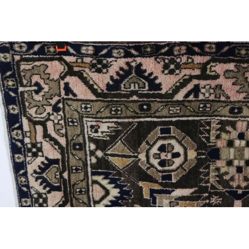 574 - Eastern Wool Red and Brown Ground Rug decorated with a geometric design within a panel, 210cm x 140c... 