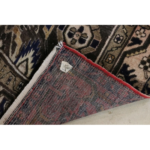 574 - Eastern Wool Red and Brown Ground Rug decorated with a geometric design within a panel, 210cm x 140c... 