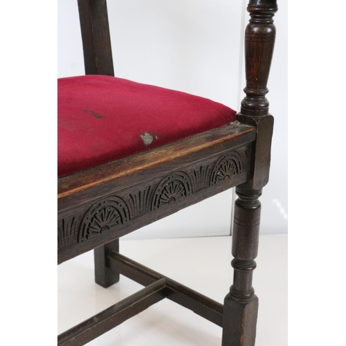 578 - In the manner of Liberty of London, Gothic Revival Oak Elbow Chair with carved back rail and upholst... 