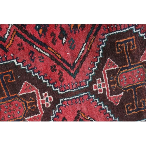 582 - Eastern Red Ground Rug with geometric pattern within a shallow border, approximately 145cm x 109cm