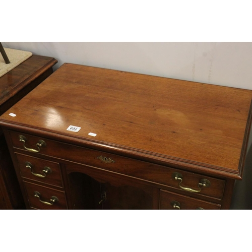 602 - George III style Mahogany Kneehole Desk with an arrangement of seven drawers and central cupboard to... 