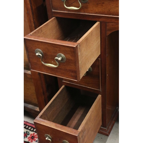 602 - George III style Mahogany Kneehole Desk with an arrangement of seven drawers and central cupboard to... 