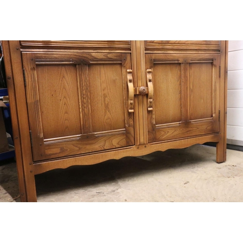 619 - Ercol ' Golden Dawn ' Elm Dresser, the upper section with two plate shelves, over a base with two dr... 