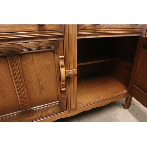 619 - Ercol ' Golden Dawn ' Elm Dresser, the upper section with two plate shelves, over a base with two dr... 