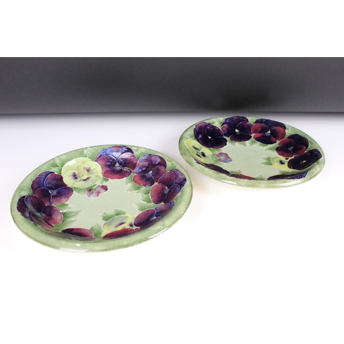 11 - Pair of William Moorcroft Shallow Bowl or Plates decorated in the pansy pattern on green ground, imp... 