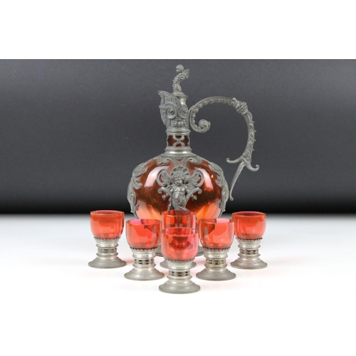 69 - Continental Art Nouveau Pewter and Red Glass Liqueur Set comprising a Decanter and Stopper 22cm high... 