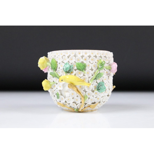 80 - Meissen flower encrusted tumbler cup, applied with canaries, on a circular saucer, chipped to unders... 