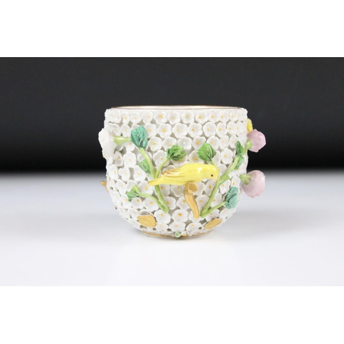 80 - Meissen flower encrusted tumbler cup, applied with canaries, on a circular saucer, chipped to unders... 