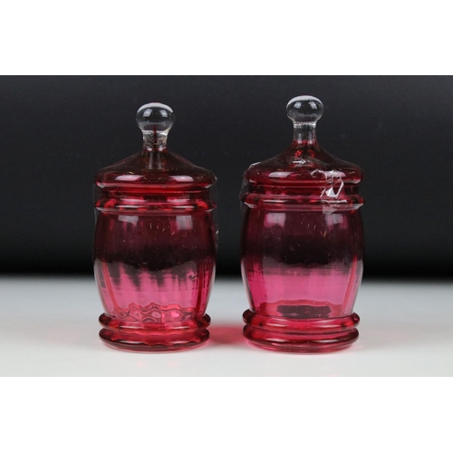 109 - A collection of glassware, to include: a pair of Victorian Cranberry glass jars and covers, a pair o... 