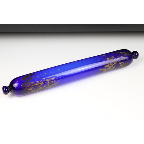 94 - Three Victorian glass rolling pins, comprising: a blue glass example, transfer decorated with ships ... 