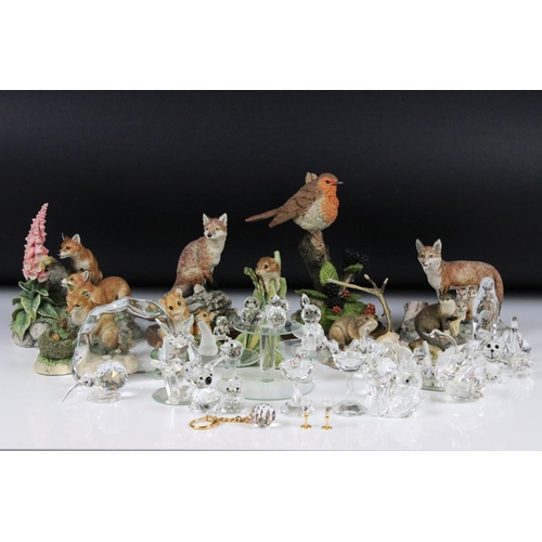 112 - A collection of Swarovski figures, to include a squirrel, a penguin and other similar glass items, t... 