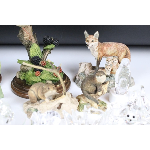 112 - A collection of Swarovski figures, to include a squirrel, a penguin and other similar glass items, t... 