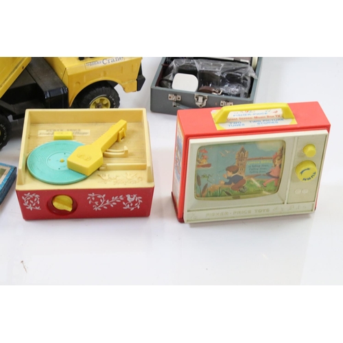 319 - A collection of late 20th century toys to include a large Tonka mobile crane, fisher price record pl... 