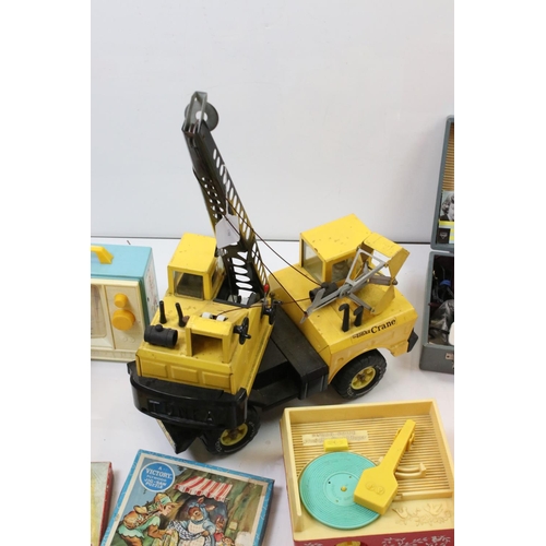 319 - A collection of late 20th century toys to include a large Tonka mobile crane, fisher price record pl... 