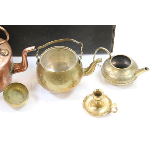 326 - A large collection of mixed brass and copper ware to include teapots, trivets, jugs, pots and plates... 