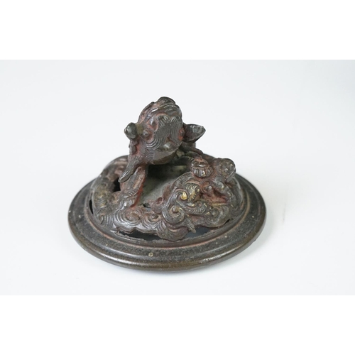 137 - Chinese bronze koro and cover, the pierced lid with a temple dog holding down another creature, the ... 
