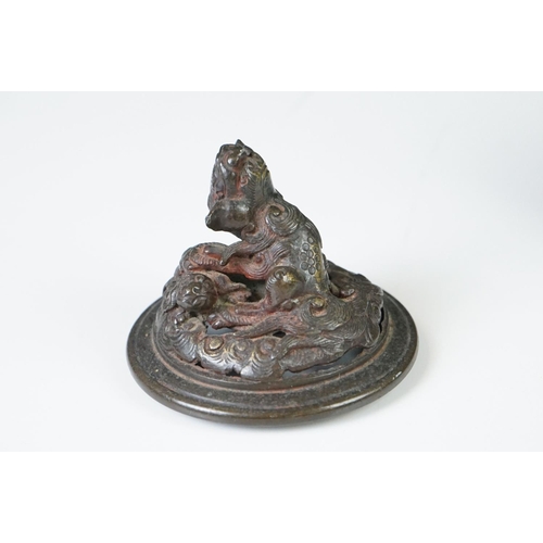 137 - Chinese bronze koro and cover, the pierced lid with a temple dog holding down another creature, the ... 