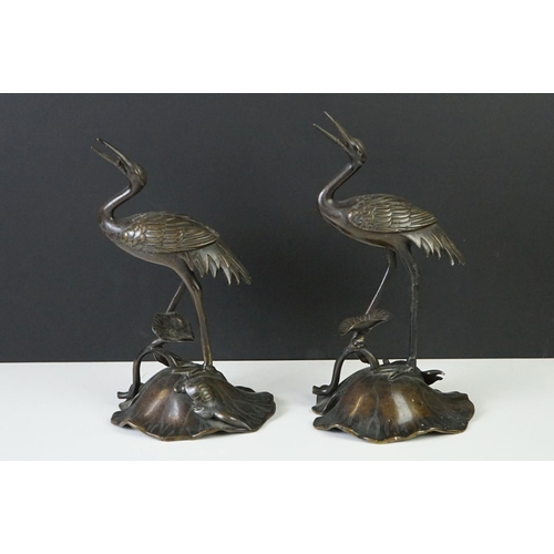 142 - Pair of 19th century bronze groups of a crane standing on a lily pad with a turtle, repaired, approx... 
