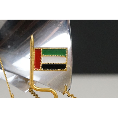 148 - Gold Plated Model of a Yacht bearing the United Arab Emirates Flag, raised on a marble base, 22cm hi... 