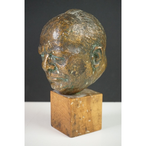 150 - Bronze Bust of Sir Winston Churchill raised on a wooden plinth, 20cm high